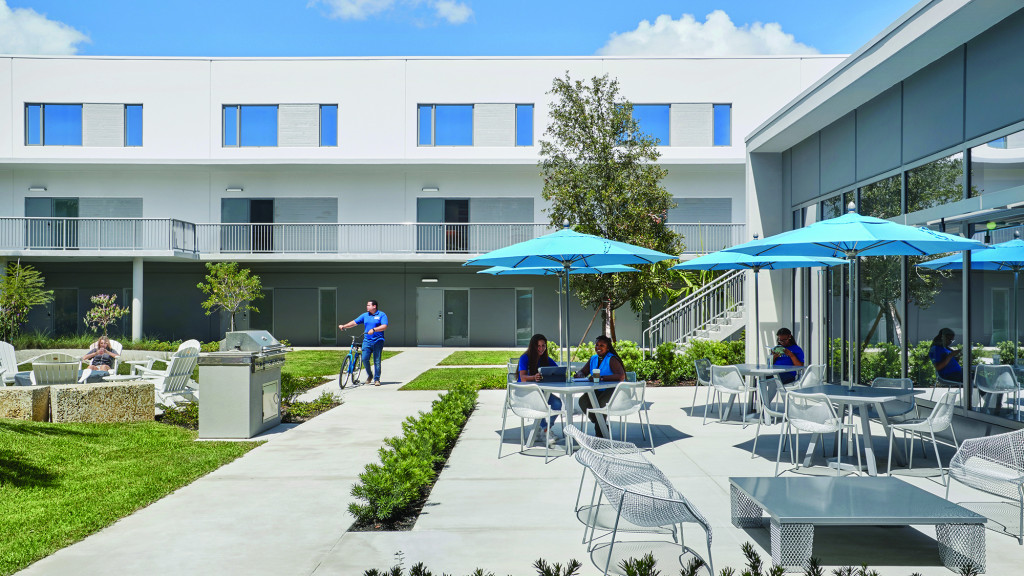 A group of people sitting outside a building.